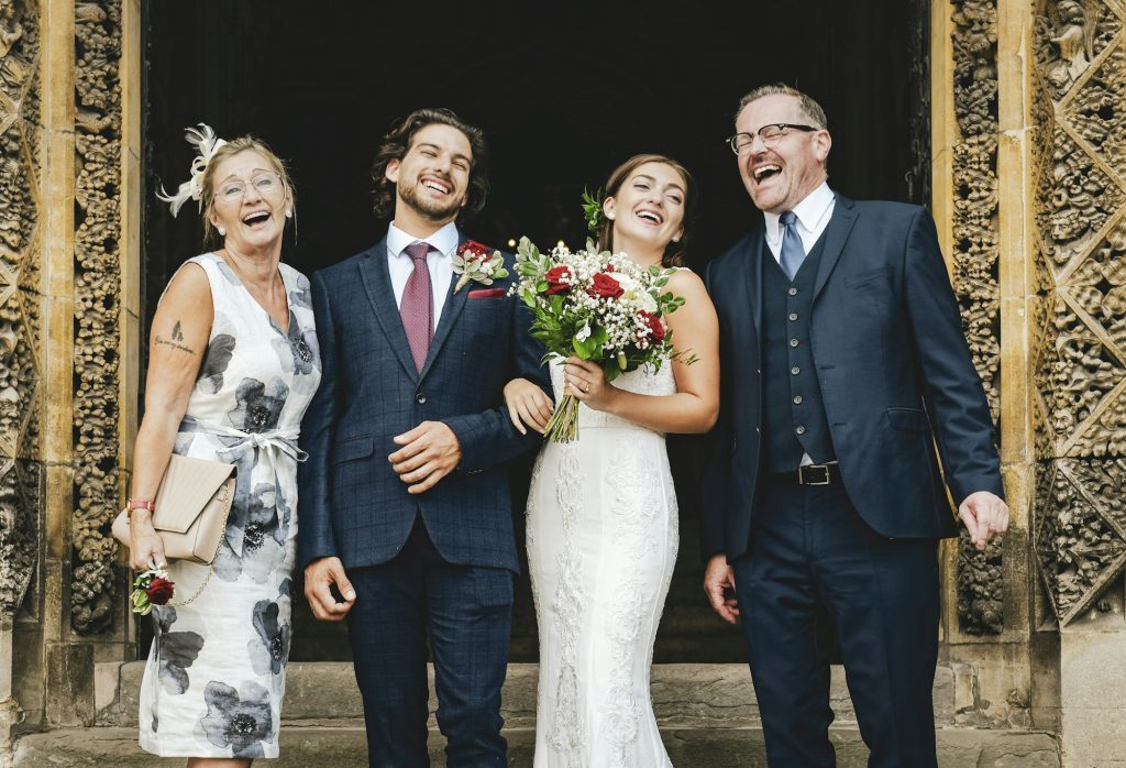 Newly weds with their family outside of church